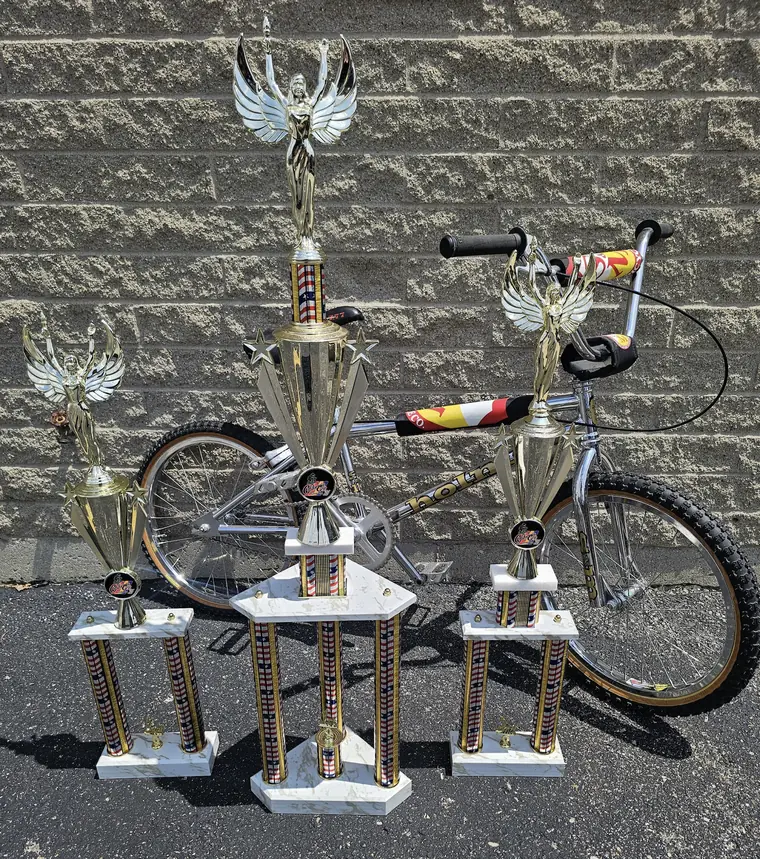 2026 Frogtown Classic trophies with red, white, and blue columns celebrating America's 250th birthday, beside a chrome BMX bike